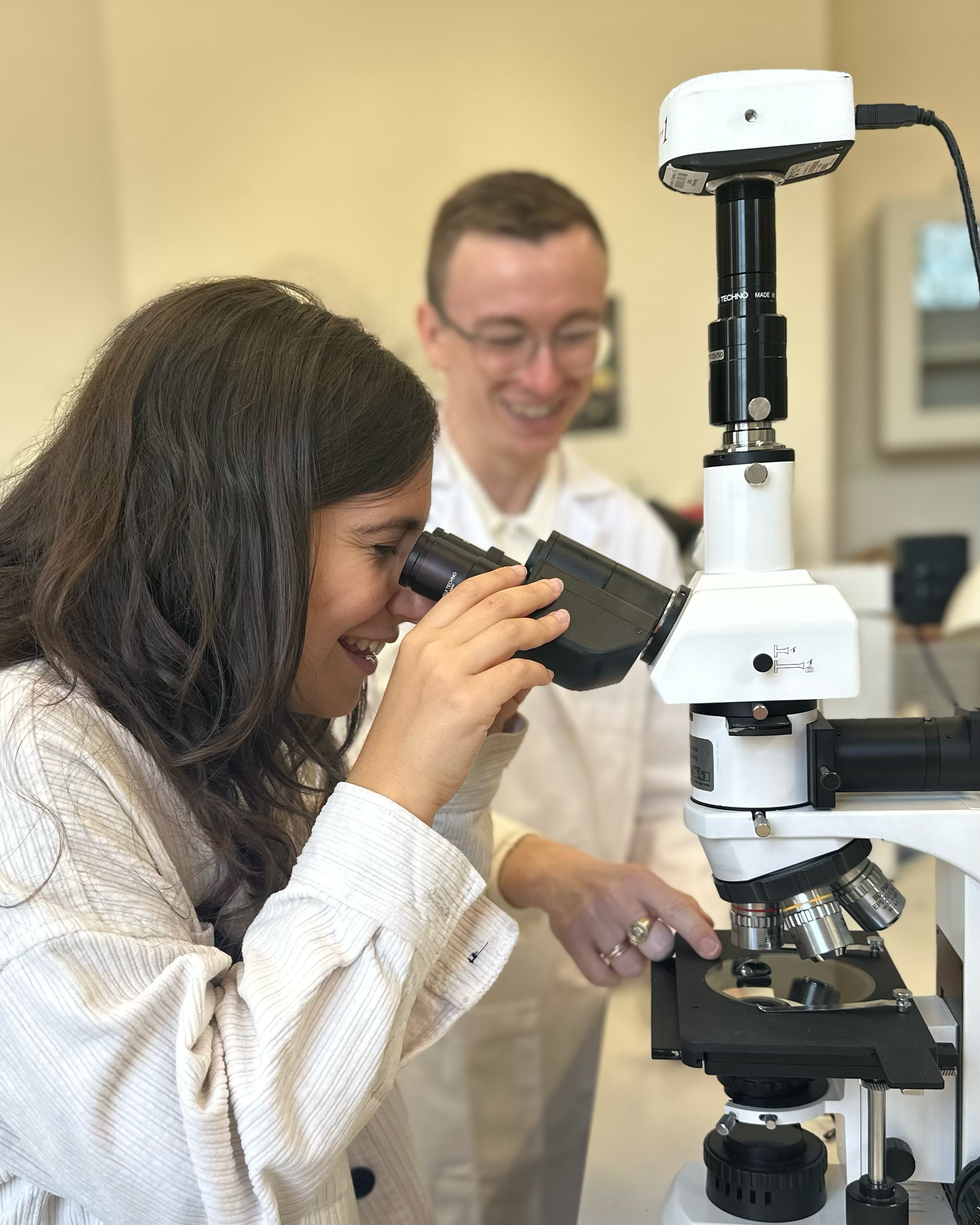 Student using microscope in laboratory session